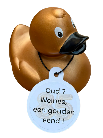Goudkleurige badeend met zwarte snavel en een hangtag met het getal 85 en de tekst ‘Oud? Welnee, een gouden eend!’.